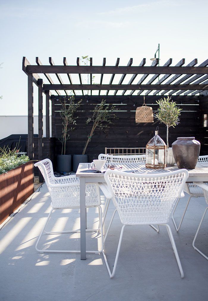 Great black timber pergola with white outdoor furniture. Pinned to Garden Design - Pergolas by Darin Bradbury.