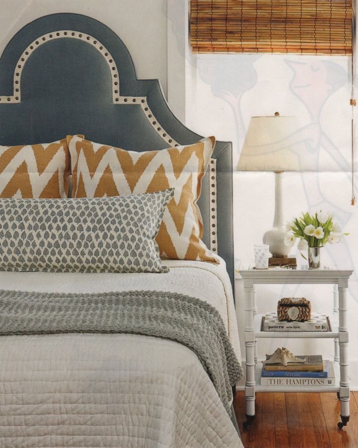 bedroom inspiration: dark gray upholstered headboard, white bedding, camel chevron pattern-
