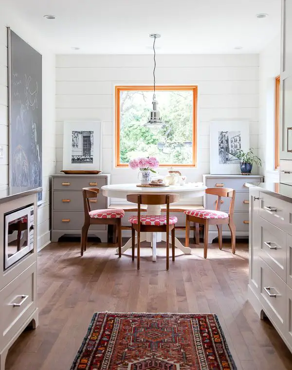 gray cabinets, that rug and under the counter microwave. Also the dressers flanking a bench seat. Great way to add some storage in an eat-in kitchen. Instead of the window add a large piece of artwork or mirror.