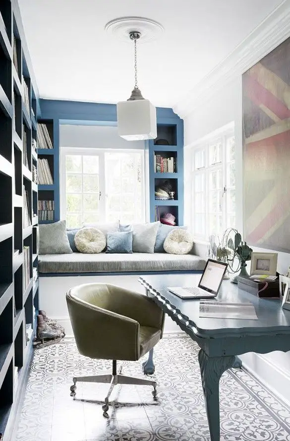 Narrow home office with window bench, modern light fixture, and large British flag art: 