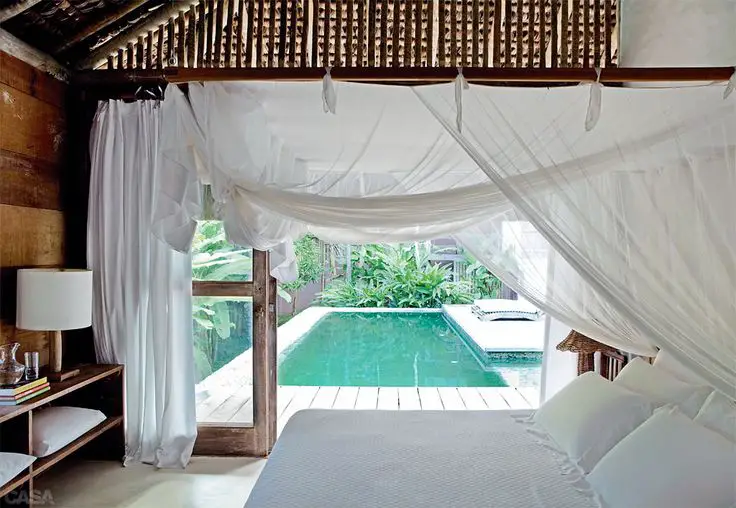Beautiful, breezy bedroom overlooking a private pool in Trancoso, Brazil.