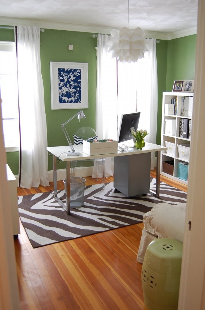 Clean office space w/ contrasting patterned rug and brightly colored walls