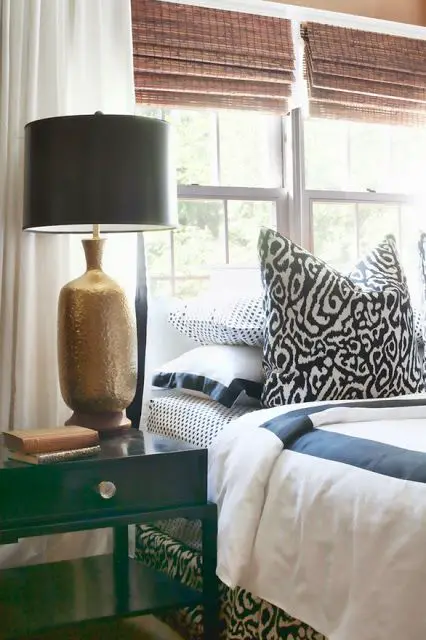 Solid neutrals mixed with patterned accents and shapely antique nightstands make the perfect case for how wonderful mixing and matching can be.: 