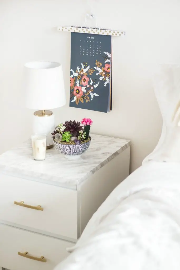 Storing accessories on you nightstand makes them easy to grab while you’re getting dressed in the morning but also makes the styling feel polished yet unfussy. The key is to stash smaller items like scarves and jewelry into baskets or dishes to keep the look from feeling cluttered.: 