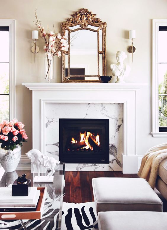 Clean, modern, and feminine take. Love the marble fireplace.: 