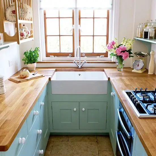I LOVE IT ALL!! horseshoe small kitchen layout with aqua cabinets and wood countertops via House to Home