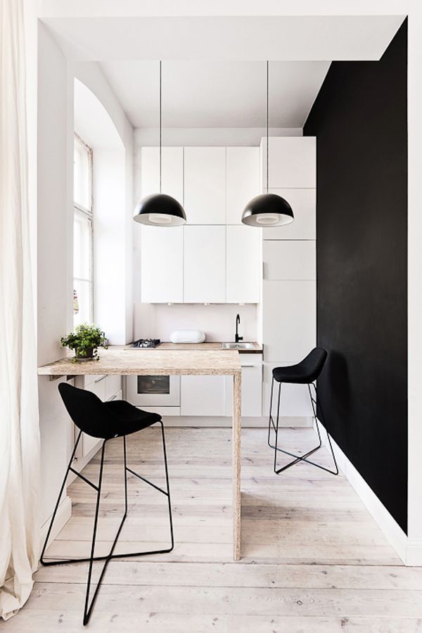 Scandinavian Style. The minimalistic addition of a stool and plant is striking.