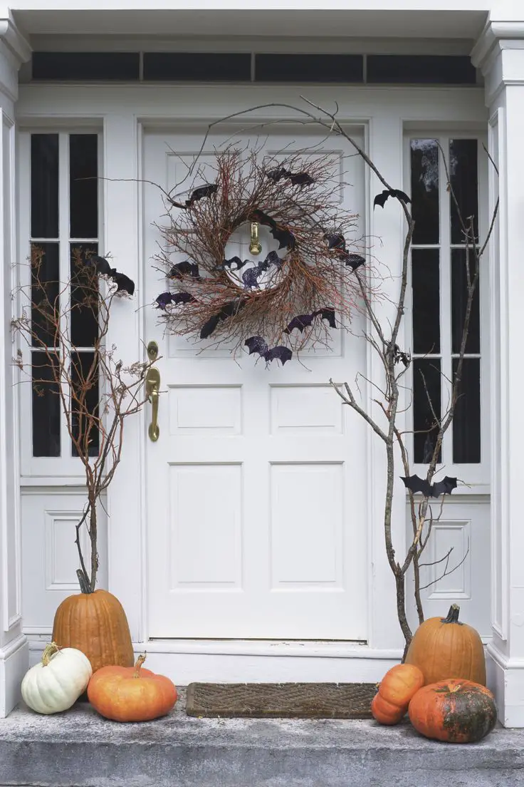 Hang a rustic spooky wreath from your door. Use vines and chic black bats. As simple as that.: 