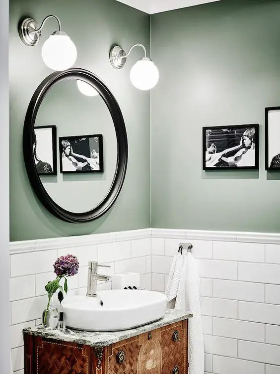 Bathroom with green walls, white subway tiles and antique vanity in a beautiful Swedish home in calm, muted tones. Entrance, Anders Bergstedt.: 