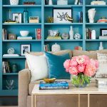 blue-built-in-bookcase-with-light-brown-sofa