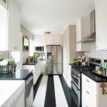 black-white-kitchen-striped-floor-hexagon-wall-tile-white-painted-cabinets-ceiling-chrome-fridge-brass-ceiling-lights-e1475692032353
