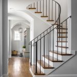 curved-staircase-with-wrought-iron-handrail