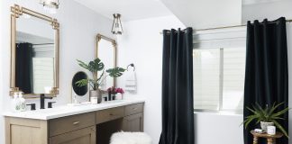 Bathroom with bath tub and black curtains