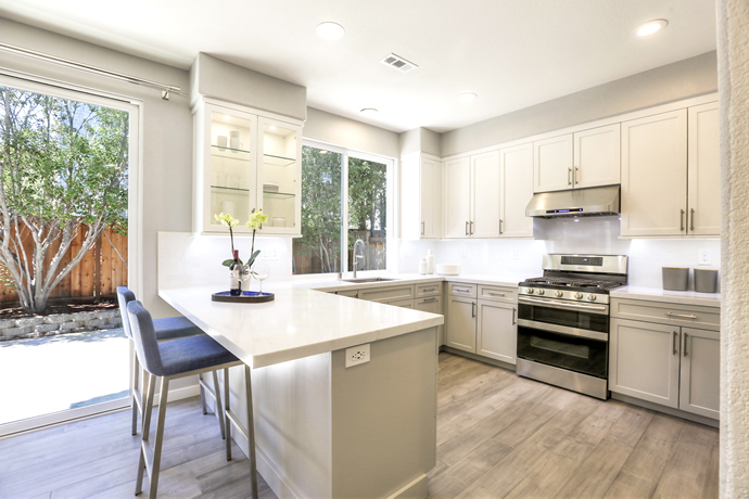 Kitchen with bar table, chairs and big window