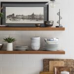 Kitchen shelf with pictures, plant and jars