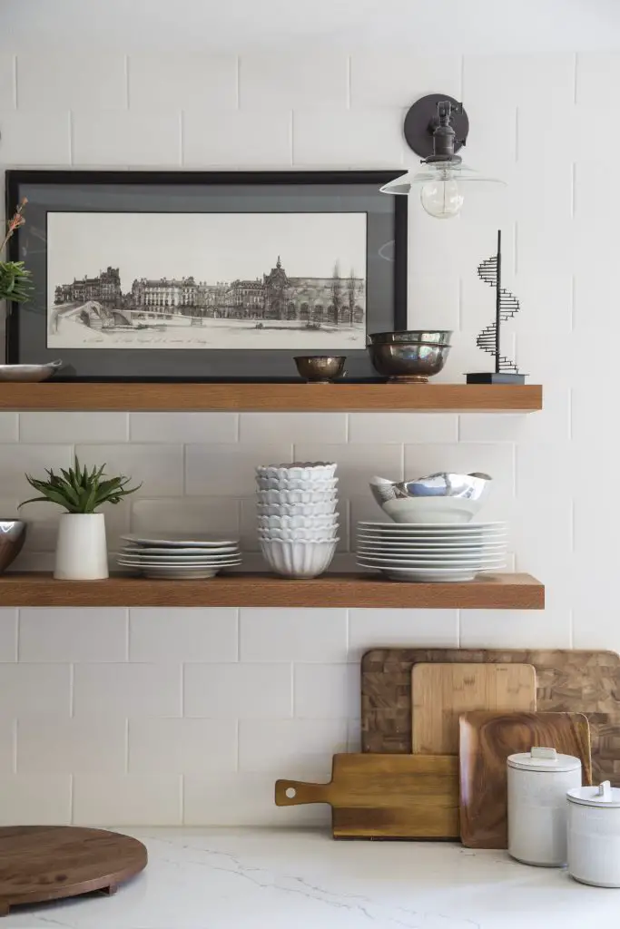 Kitchen shelf with pictures, plant and jars