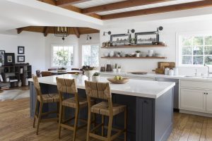 Kitchen with big table, bar chairs and kitchen elements