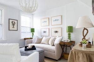 Living room with couch, tables with lamps and pictures