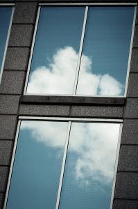 Windows on the building reflecting clouds