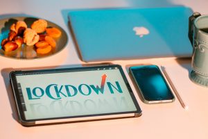 McBook, tablet and mobile phone with dried fruit on the plate