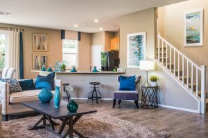 Living room with stair, coffee table with vases and  chairs