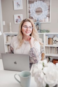 Woman at home office table with Mac