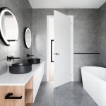 Bathroom with tub and mirrors