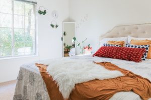 Decorated bedroom with double bed and mirror