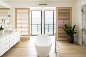 Bathroom with tub on beach shore