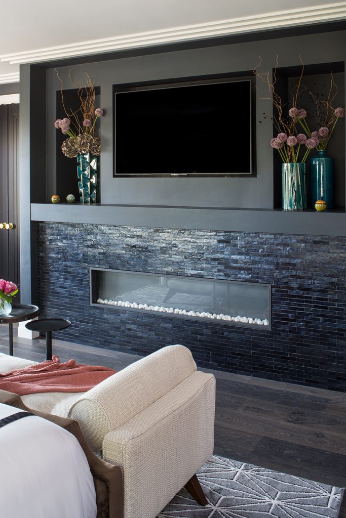 Dark living room with couch, chairs and tv