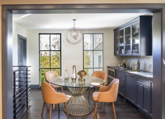 Kitchen with round glass table and orange chairs