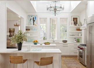 White designed kitchen with table, chairs and kitchen elements