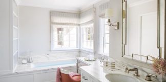 Master bathroom with sink, tub and chair