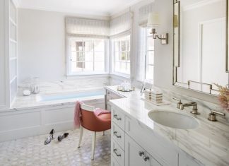 Master bathroom with sink, tub and chair