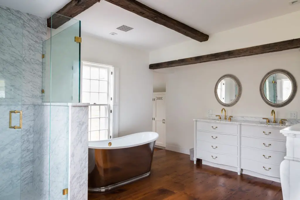 Bathroom with designed bath tub, mirror and sink