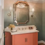 Master bathroom with orange and white sink and mirror