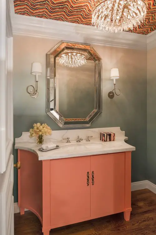 Master bathroom with orange and white sink and mirror 