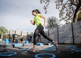 Woman running at outdoor gym