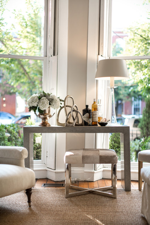 Table with flowers, statue and lamp