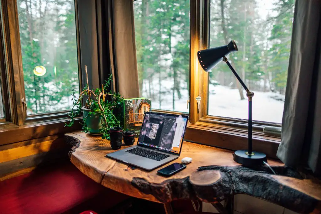 Wood-designed home office with desk, laptop and lamp