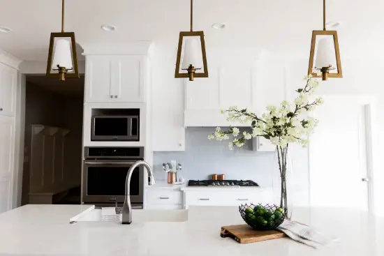 Kitchen with white kitchen cabinet and flowers on kitchen table