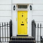 Yellow entrance door on the white house