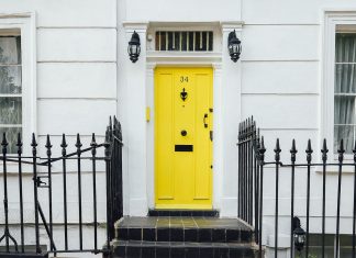 Yellow entrance door on the white house