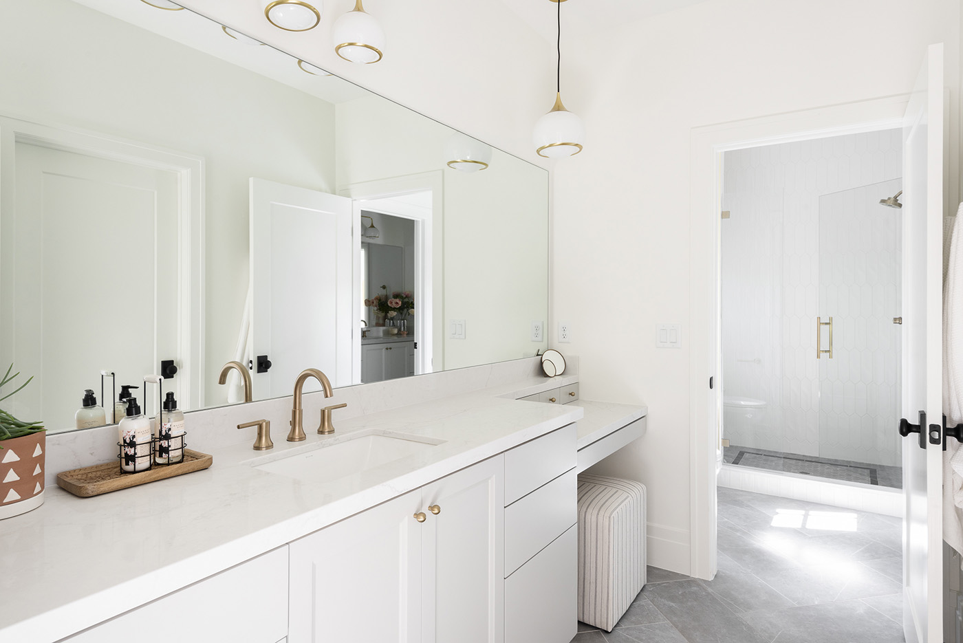 White bathroom with sink and large mirror 