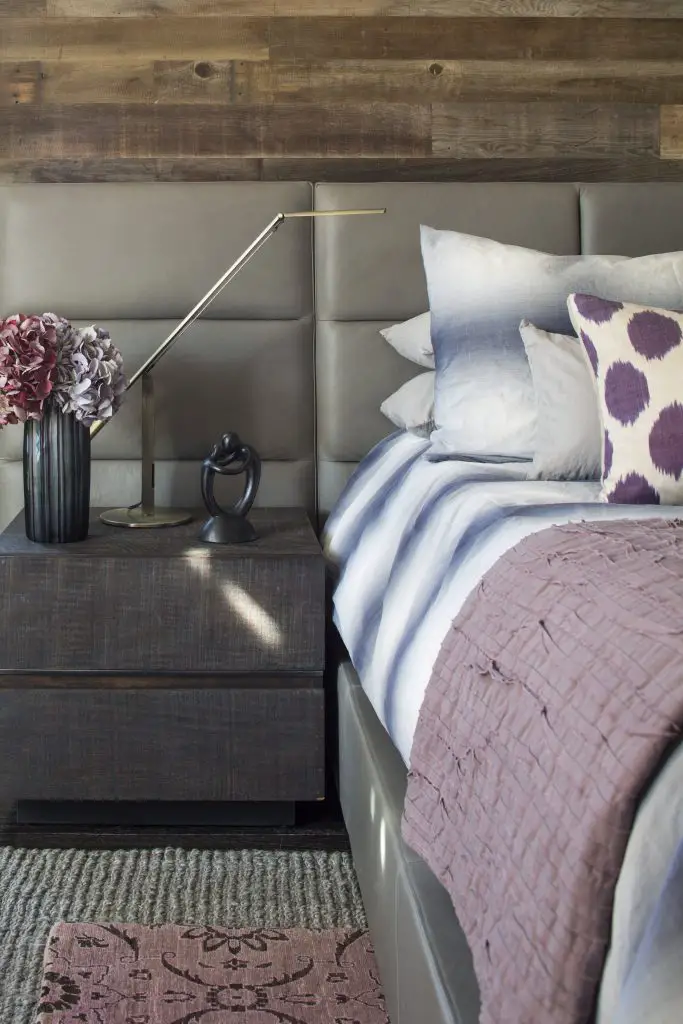 Closeup of the bed and night cupboard in bedroom