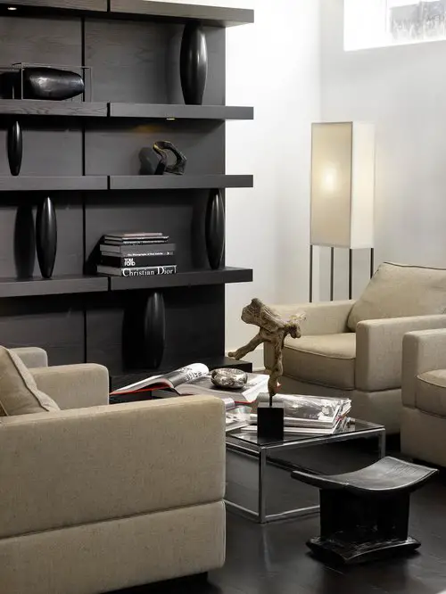 Designed basement living room space with armchairs, book shelfs and a lap