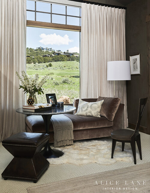 Sofa, table and chairs in the corner of the room with big window