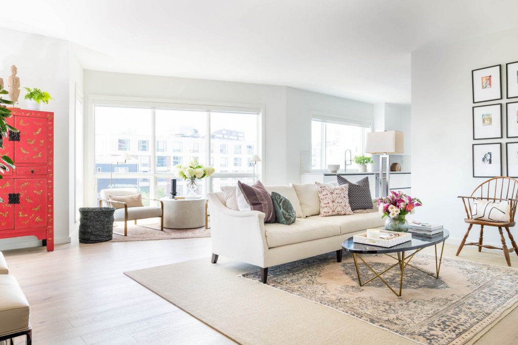 Living room in bright neutral colors with sofa, coffee table, chairs and armchairs