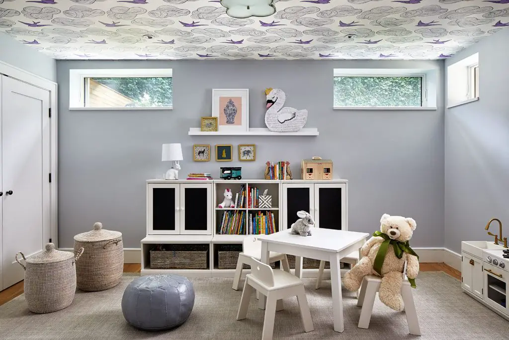 Children's playroom with toys, books and table with chair