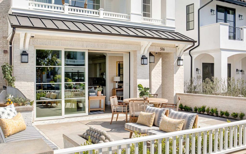 Fenced yard with tables, chairs, and sofa